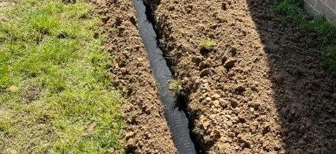 Drainage system installed to resolve flooding and wash out issues. 